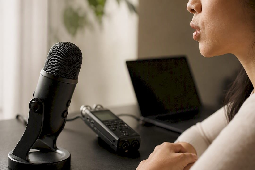 Close-up of mouth and recording setup for pronunciation practice